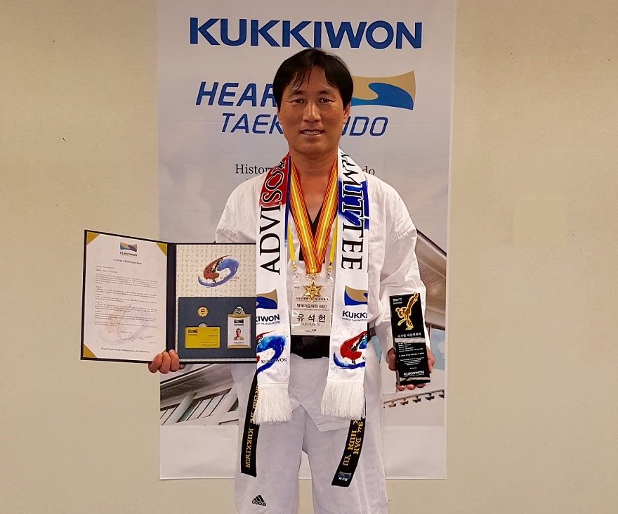 GrandMaster Yu with his International Advisory Board recognition, appointment letter, and plaque
